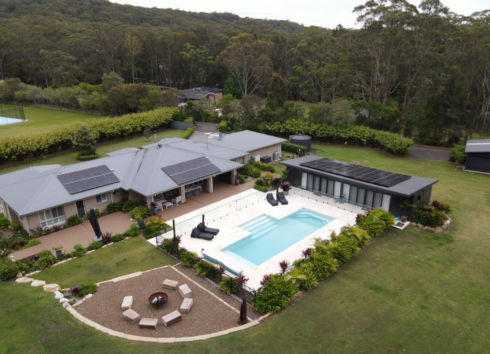 Solar panels installed on a Sunshine Coast home with pool and poolhouse